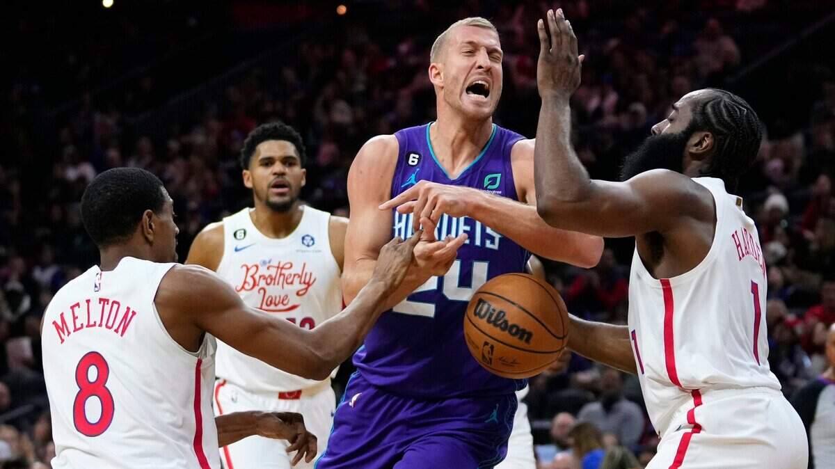 Charlotte Hornets’ Mason Plumlee cannot get a shot off against Philadelphia 76ers’ James Harden, right, and De’Anthony Melton during the first half of an NBA basketball game, Sunday, Dec. 11, 2022, in Philadelphia. (AP Photo/Matt Slocum)