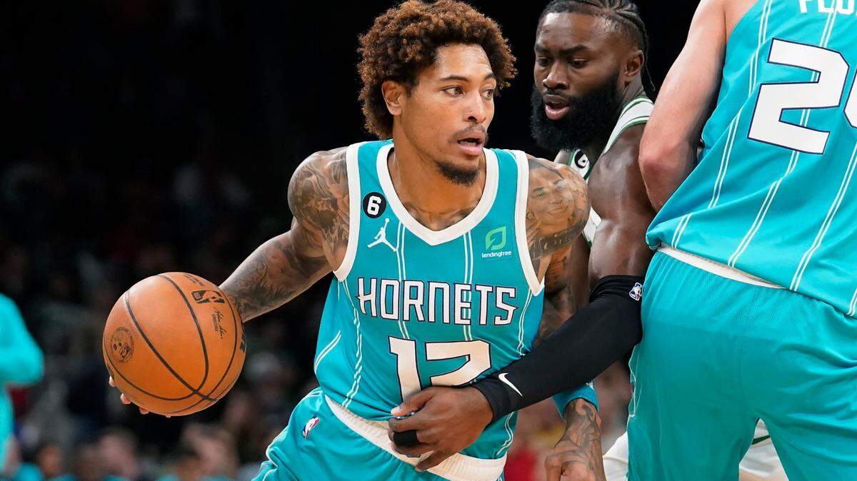 Charlotte Hornets’ Kelly Oubre Jr., left, tries to drive past Boston Celtics’ Jaylen Brown, center right, in the first half of a preseason NBA basketball game, Sunday, Oct. 2, 2022, in Boston. (AP Photo/Steven Senne)