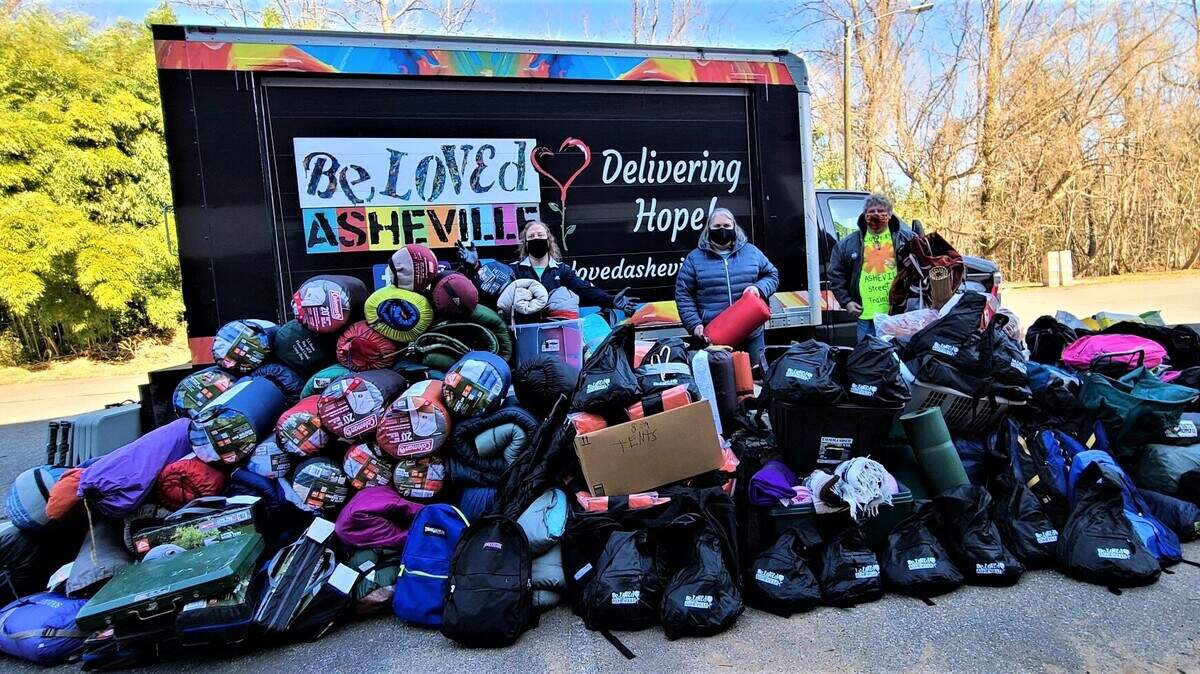 The street medic team at BeLoved Asheville trains people who are currently or formerly unsheltered in basic medical skills like first aid, wound care and overdose prevention. They also distribute flyers about the covid vaccines and ask people if they’ll pledge to get their shots. (Ponkho Bermejo)