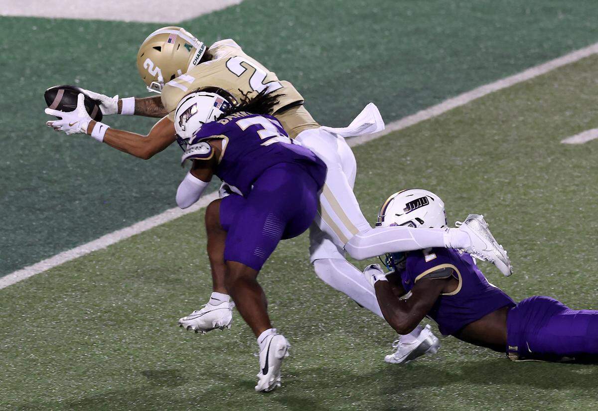 Charlotte 49ers wide receiver Isaiah Myers, left, dives into the end zone for a touchdown following a pass reception from quarterback Max Brown during action against James Madison University on Saturday, August 31, 2024 at Jerry Richardson Stadium.
