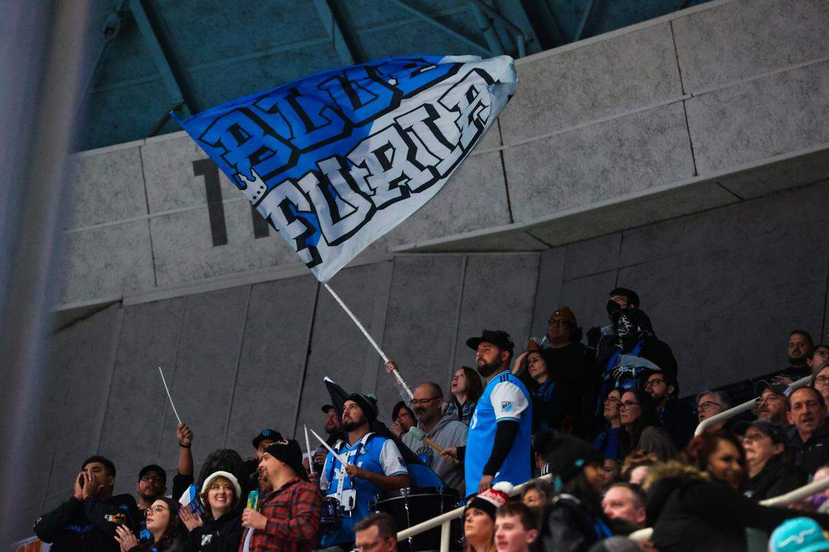 Blue Furia, a supporters group for MLS club Charlotte FC, attends a Charlotte Checkers game on Dec. 3, 2022.