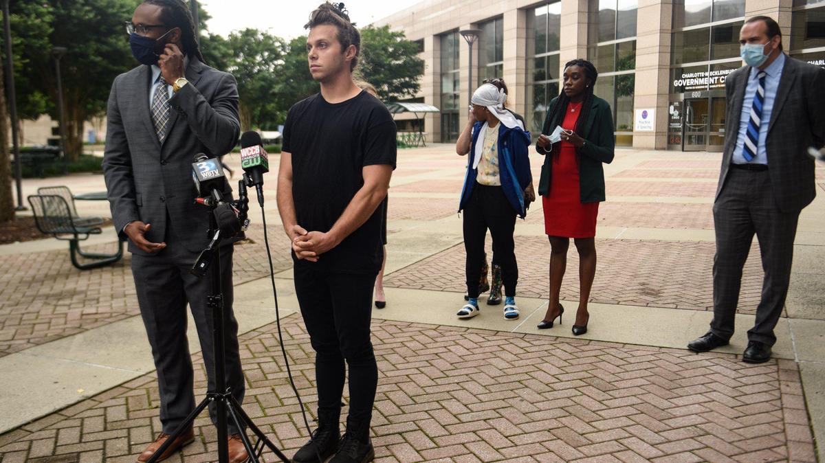 (From left) Attorney Dominique Camm and his client Jamie Marsicano, a member of Charlotte Uprising, field questions during a press conference at the Charlotte Government Center on June 17, 2020 addressing events during which police threatened to arrest them while attempting to see their clients, as well as police conduct and use of force.