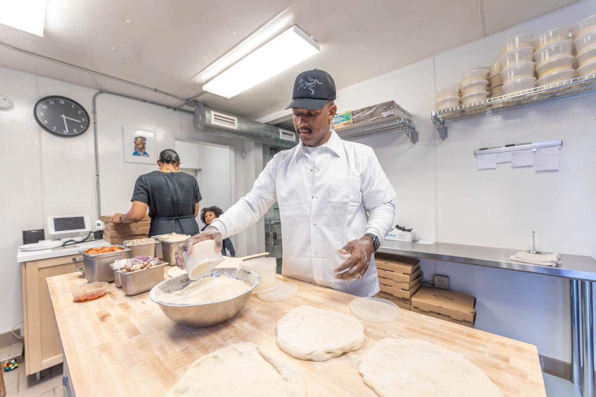 Kerrel Thompson prepares 14-inch pizzas at Bird Pizzeria in Charlotte.