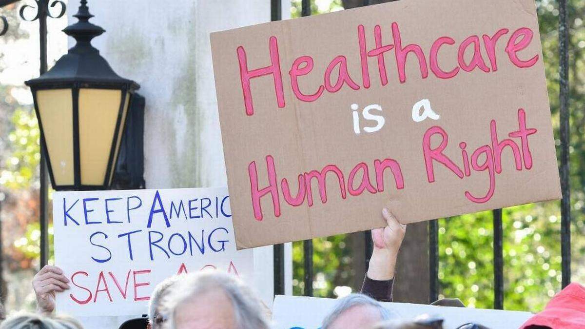 Affordable Care Act supporters hold up handmade signs at a South Carolina rally in 2017. On June 17, 2021 the U.S. Supreme Court rejected the latest major Republican-led effort to kill the ACA, preserving insurance coverage for millions of Americans.