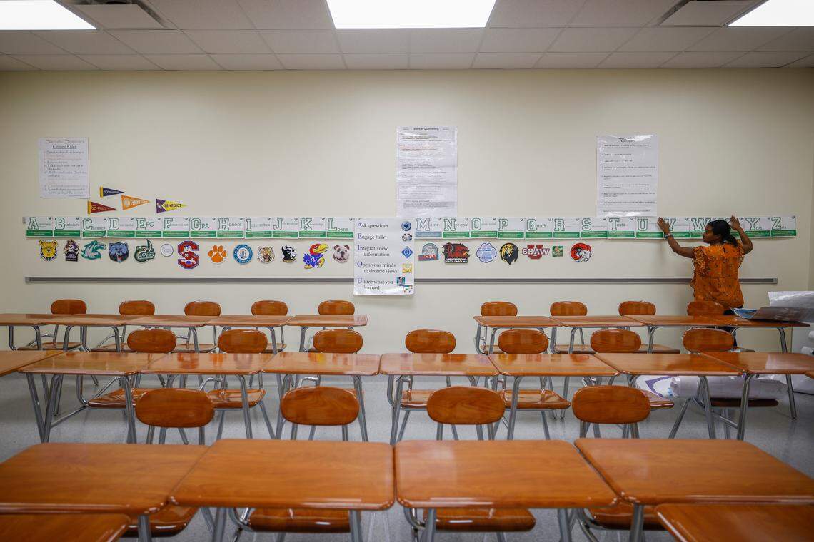 CTE teacher Carita Evans, of Charlotte, N.C.,works to decorate her classroom at West Charlotte High School in Charlotte, N.C., Friday, Aug. 26, 2022.