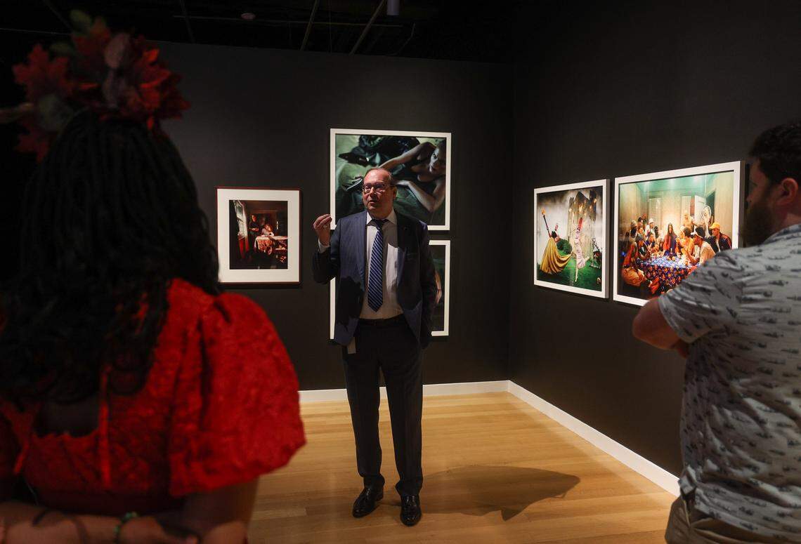 Mint Museum CEO and President Todd Herman, center, discusses photographic work by Tom Hunter, Glen Luchford and David LaChapelle that was influenced by Caravaggio during a media preview at the Mint Museum on Thursdayay, April 23, 2026.