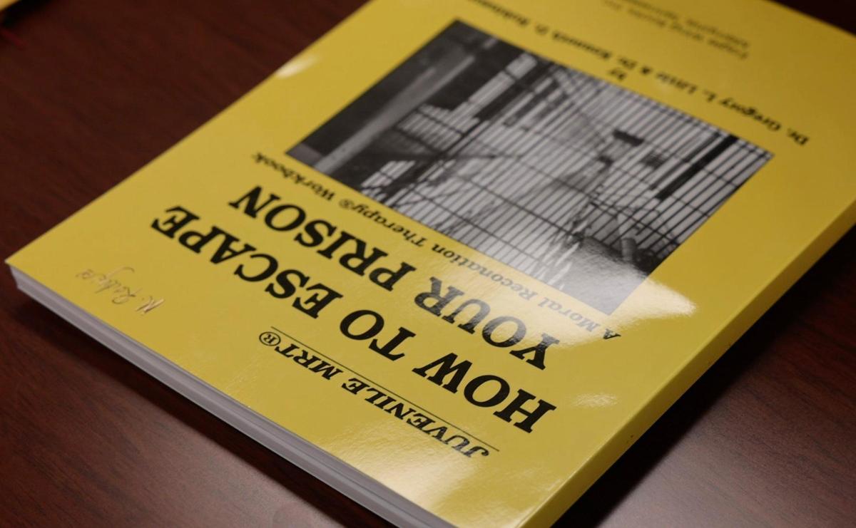 A workbook titled “How to Escape Your Prison” is used in a class at the Juvenile Court Intervention Program.