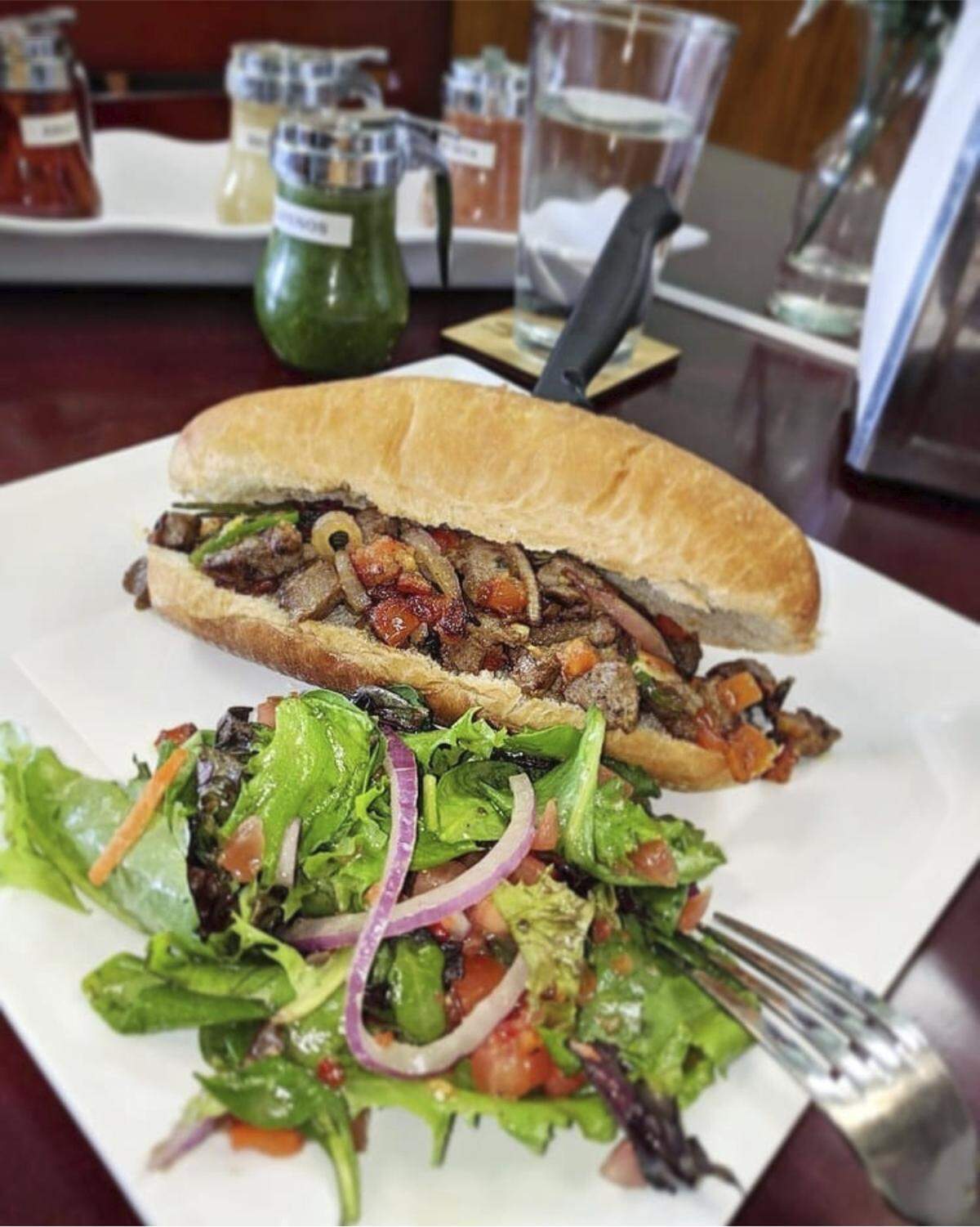 Enat restaurant in Charlotte puts traditional Ethiopian tibs, a rich meat-and-gravy dish, on an American hoagie roll.