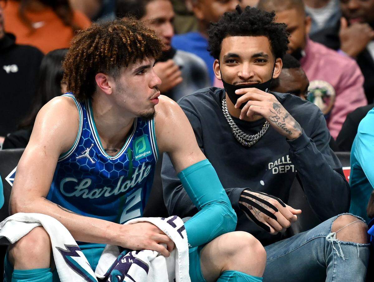 Charlotte Hornets guards LaMelo Ball, left and James Bouknight, right, sit on the teamÕs bench during third quarter action at Spectrum Center in Charlotte, NC on Wednesday, February 9, 2022. The Bulls defeated the Hornets 121-109.