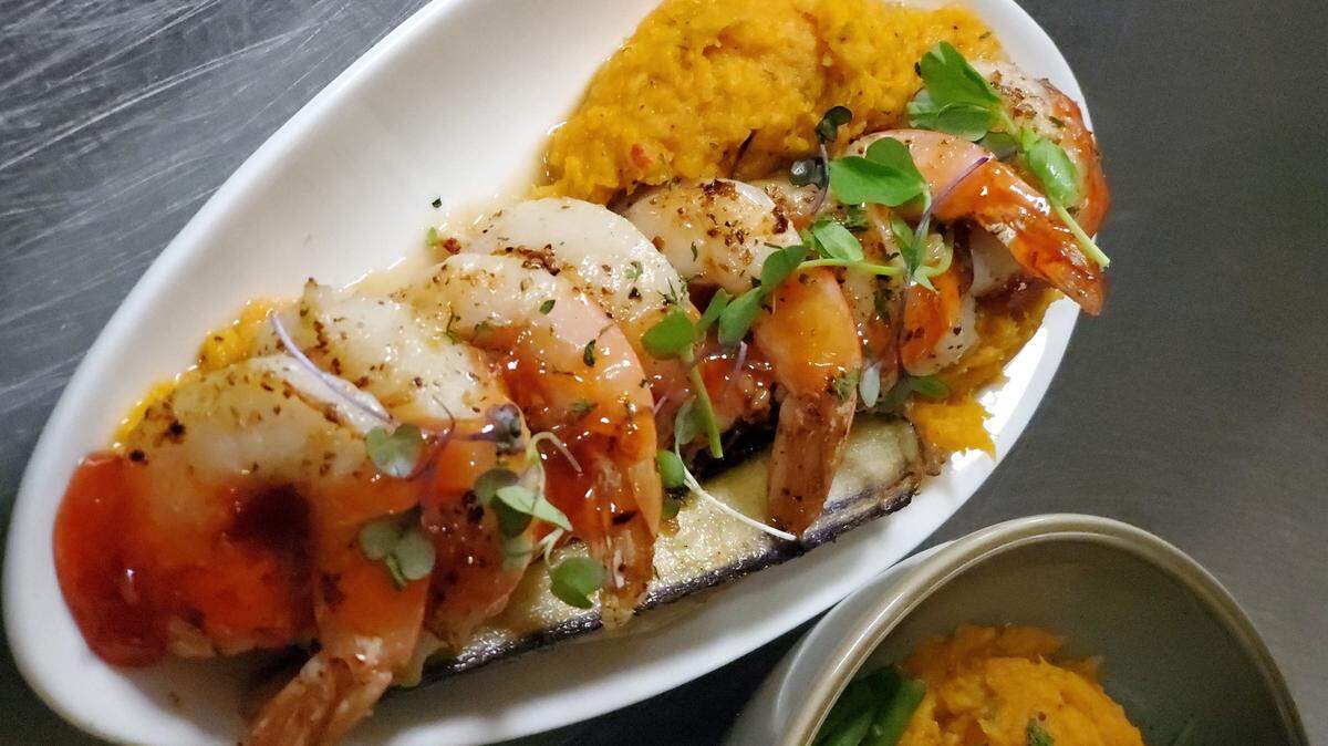 Shrimp and Scallops Caponata with sweet potato mash, roasted medley carrots and a sweet and spicy caper sauce.
