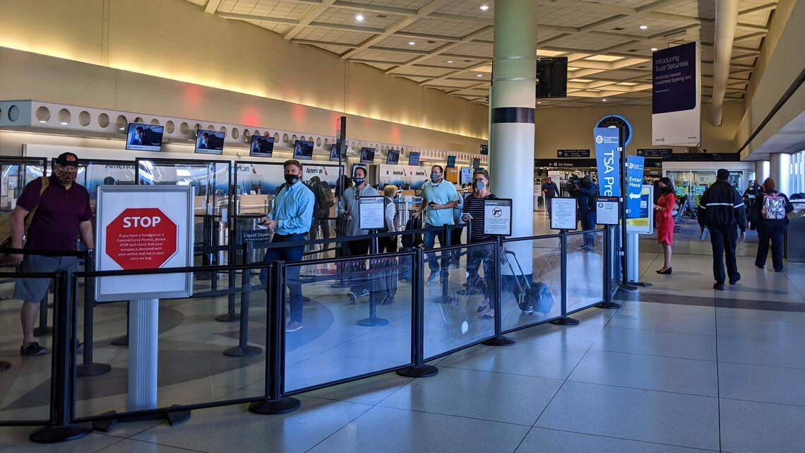 Passengers wait in line at the American Airlines ticket counter at Charlotte Douglas International Airport Wednesday, November 18, 2020. American Airlines is preparing for a spike in traffic out of hub ahead of Thanksgiving.