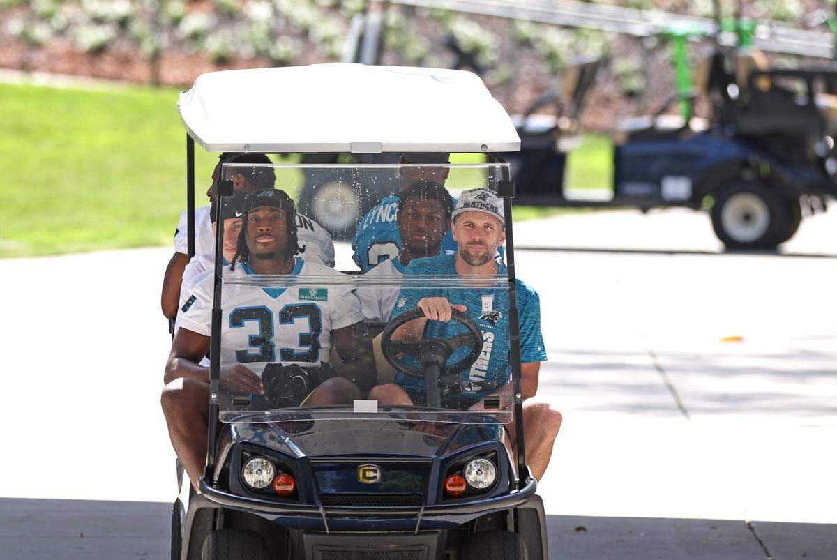 Carolina Panthers rookie linebacker Princely Umanmielen, left, gets a ride to the team’s rookie minicamp practice on Friday, May 9, 2025.