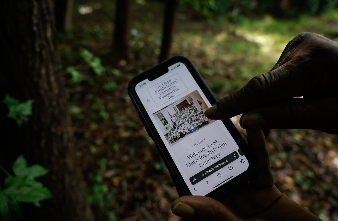 Wayne Johnson, Vice President of the St. Lloyd Presbyterian Cemetery Foundation, points to himself as a young boy in an old congregation photo on the foundsation’s website in Charlotte on Monday, July 8, 2024.