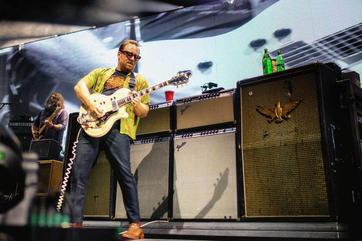 The Black Keys’ Dan Auerbach jams in front of a row of amplifiers on stage in Charlotte.