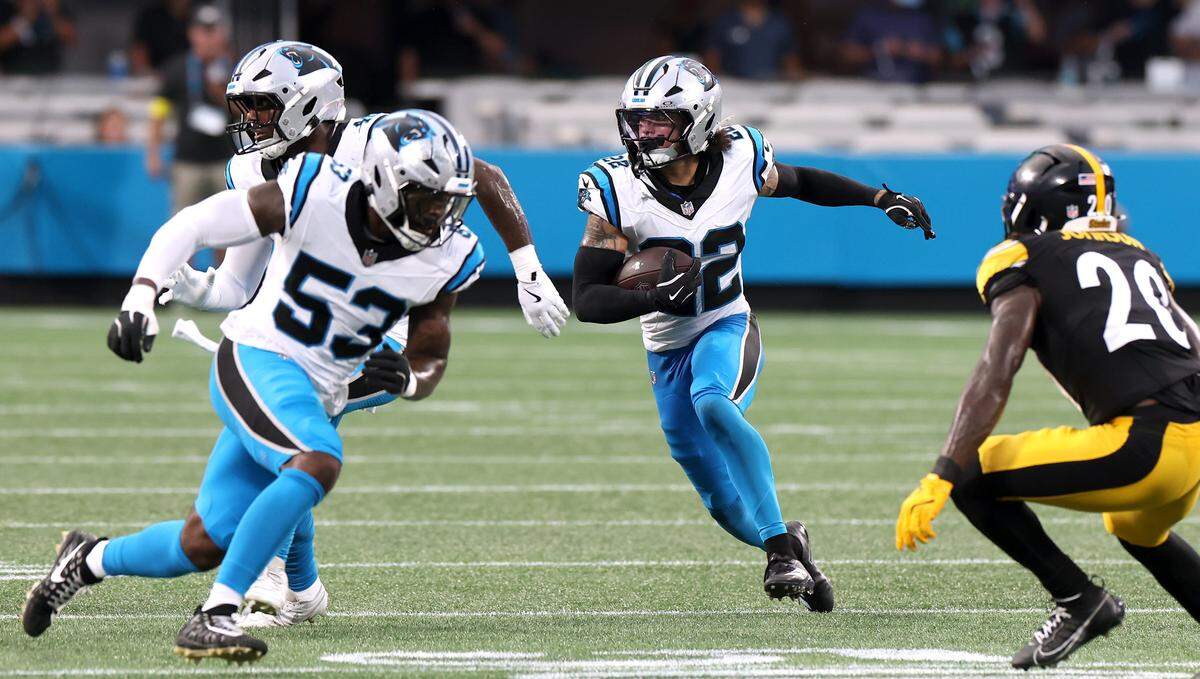 Carolina Panthers safety Lathan Ransom, center, intercepts a pass by the Pittsburgh Steelers at Bank of America Stadium in Charlotte, NC on Thursday, August 21, 2025.