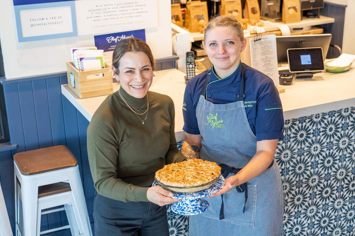 Owner of Chef Alyssa’s Kitchen, Alyssa Wilen, and executive pastry chef Brittany Nolen hold a caramel bourbon apple pie.