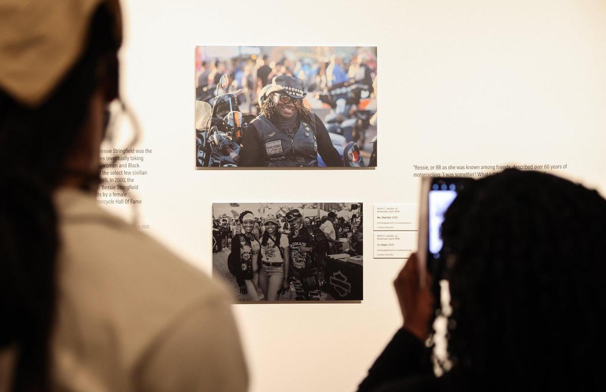 Attendees admire the photos in “Black Behind Bars: The Untold Story of Black Bike Culture” by photographer Alvin C. Jacobs Jr. Jacobs is part of three generations of Black bikers. His work at the Gantt will be on display through Sept. 21.