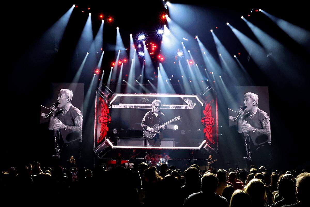Journey lead vocalist Arnel Pineda, left and right, and founder and lead guitarist Neal Schon, center, are projected onto a large video board during the bands Final Frontier Tour at Spectrum Center in Charlotte, NC on Wednesday, May 20, 2026