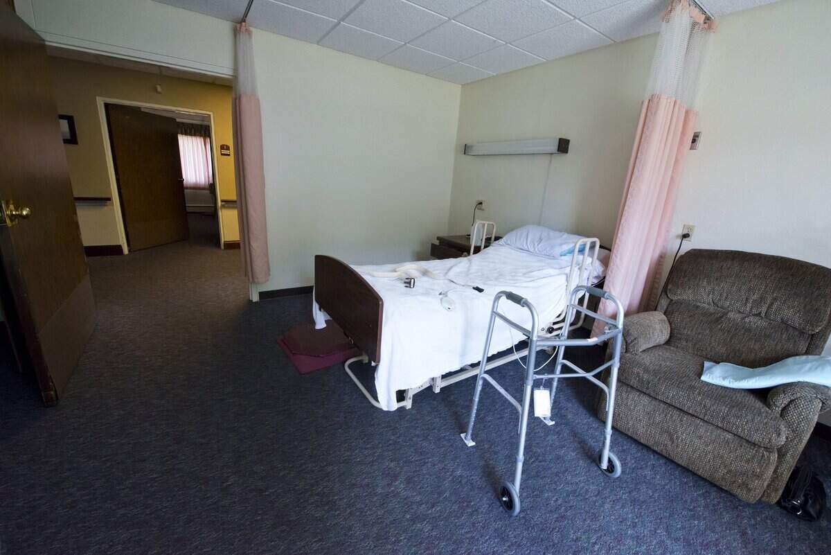 This file photo shows a bed in a skilled nursing facility.