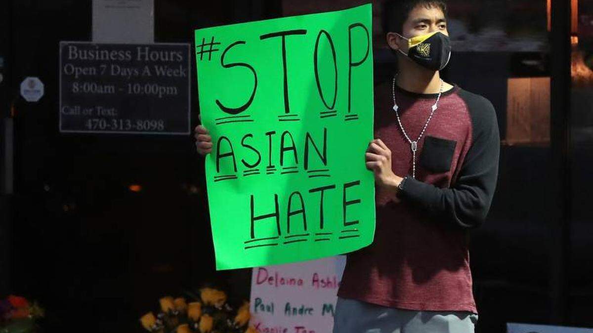 Jesus Estrella of Kennesaw, Ga., stands outside Youngs Asian Massage in Acworth, Ga., where four people were fatally shot Tuesday.
