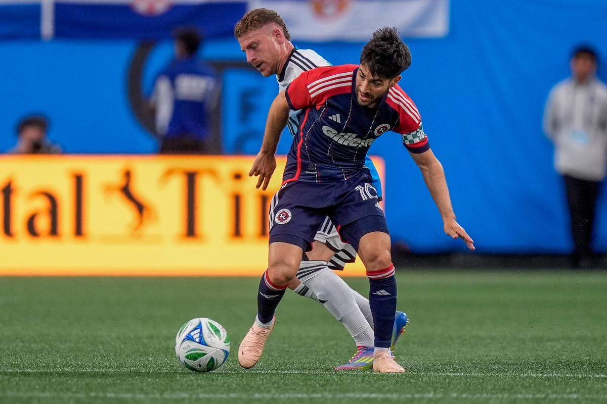 Charlotte FC midfielder Pep Biel (16) pressures New England Revolution midfielder Carles Gil (10) during Saturday’s first half at Bank of America Stadium. Jim Dedmon-Imagn Images