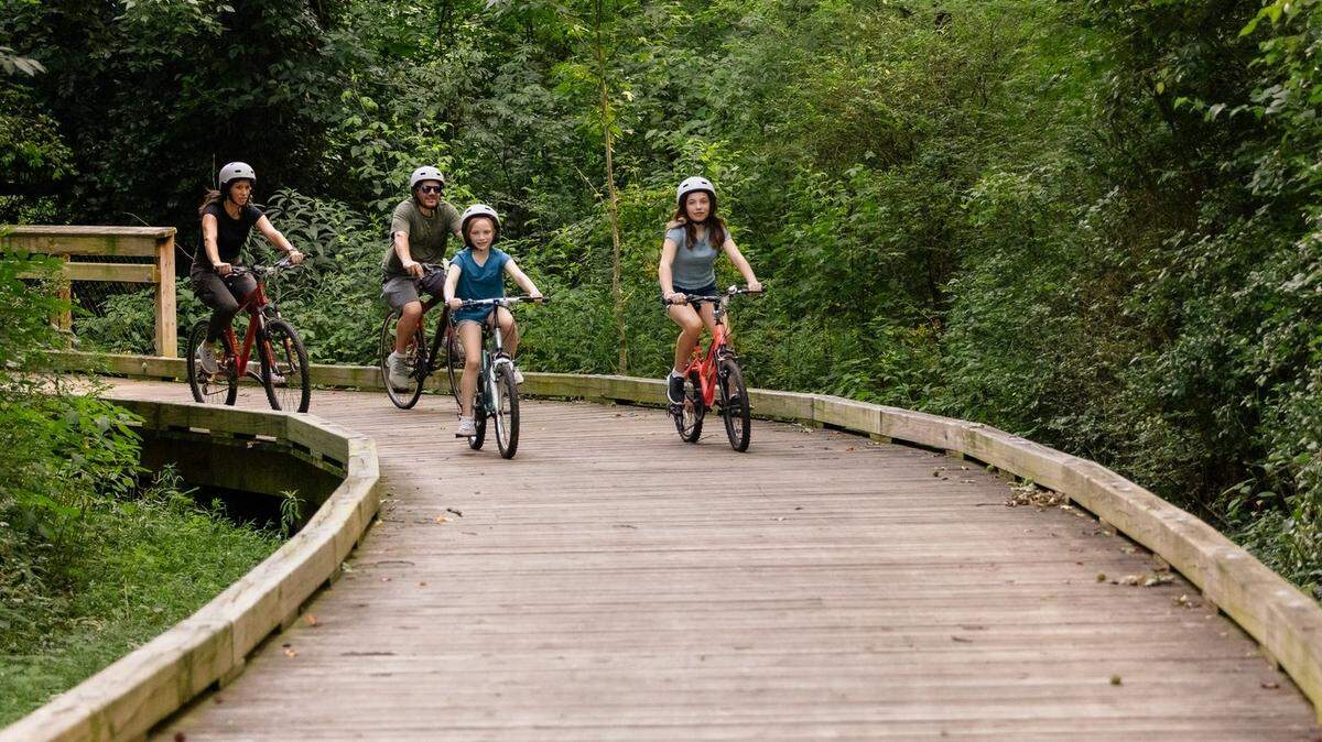 Bikers enjoy the 2.6-mile Caldwell Station Creek Greenway in Cornelius, NC.