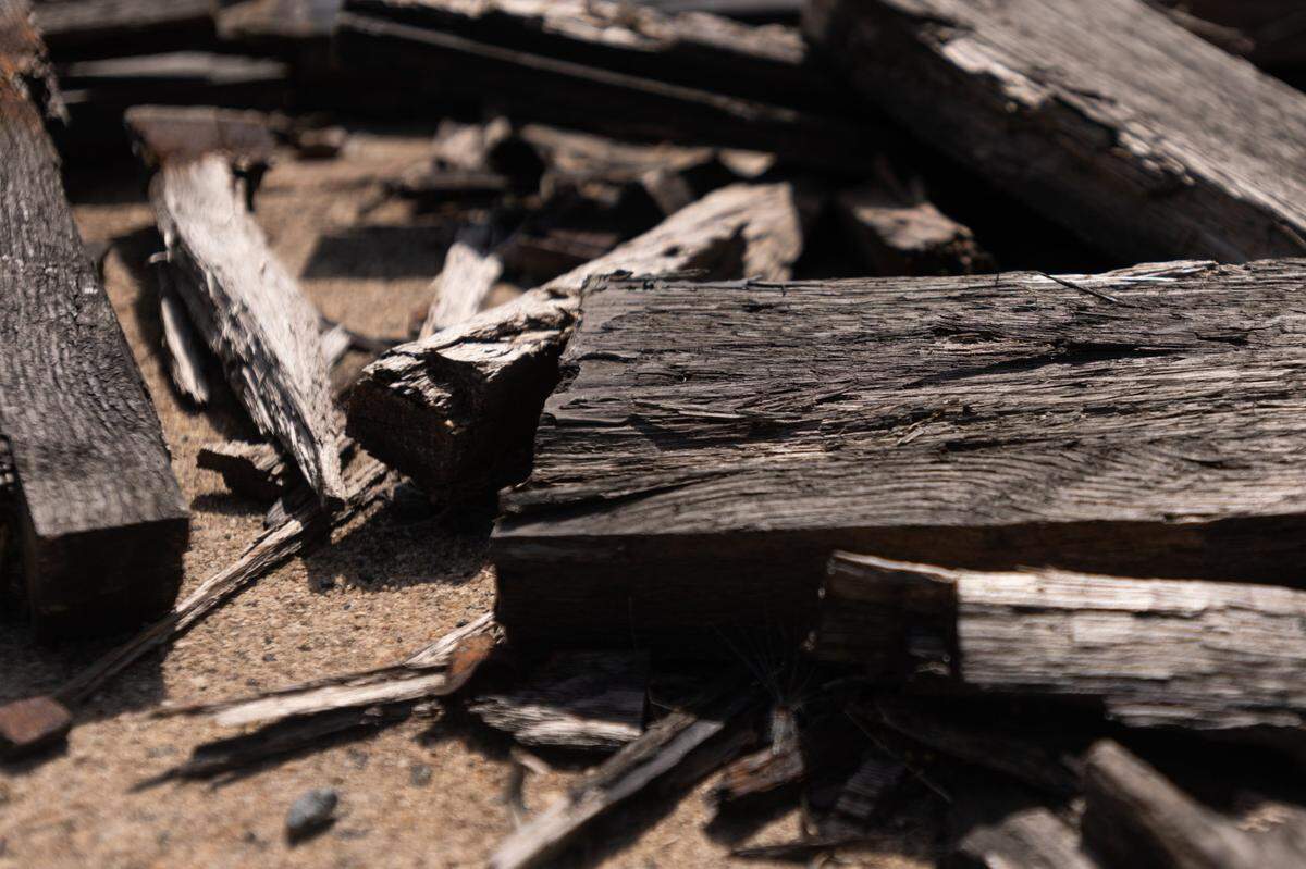 Wood and debris lay scattered around the foundation where the Eastland Mall once stood in Charlotte, N.C., Monday, July 25, 2022.