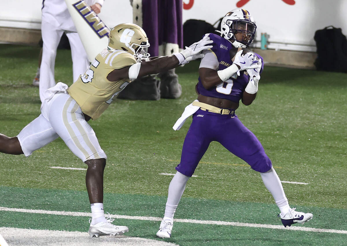 Charlotte 49ers linebacker Prince Wallace-Bemah, left, is unable to stop James Madison University running back George Pettaway, right, from catching a touchdown pass during action on Saturday, August 31, 2024 at Jerry Richardson Stadium.