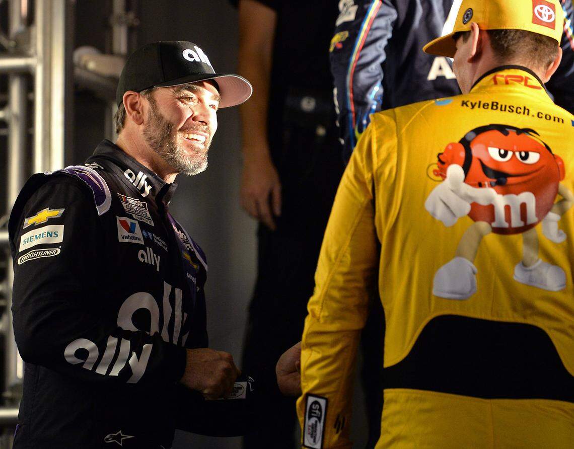 NASCAR driver Jimmie Johnson, left, jokes with driver Kyle Busch, right, during driver introductions at Daytona International Speedway in Daytona Beach, FL. on Thursday, February 13, 2020