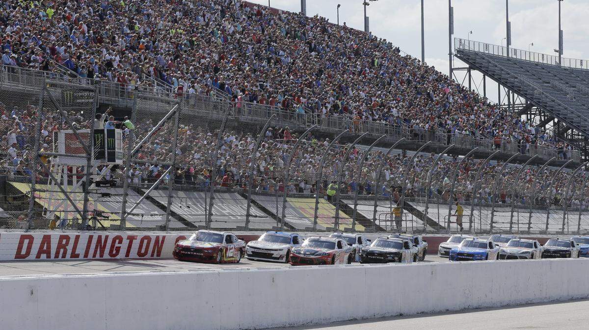 FILE - In this Aug. 31, 2019, file photo, Ryan Blaney leads the field to the start the NASCAR Xfinity Series auto race at Darlington Raceway in Darlington, S.C. NASCAR will resume its season without fans starting May 17 at Darlington Raceway in South Carolina. As NASCAR speeds back to the race track during the coronavirus pandemic the series has a heavy responsibility to set a safety standard that doesn’t slow the return of other sports. (AP Photo/Terry Renna, File)