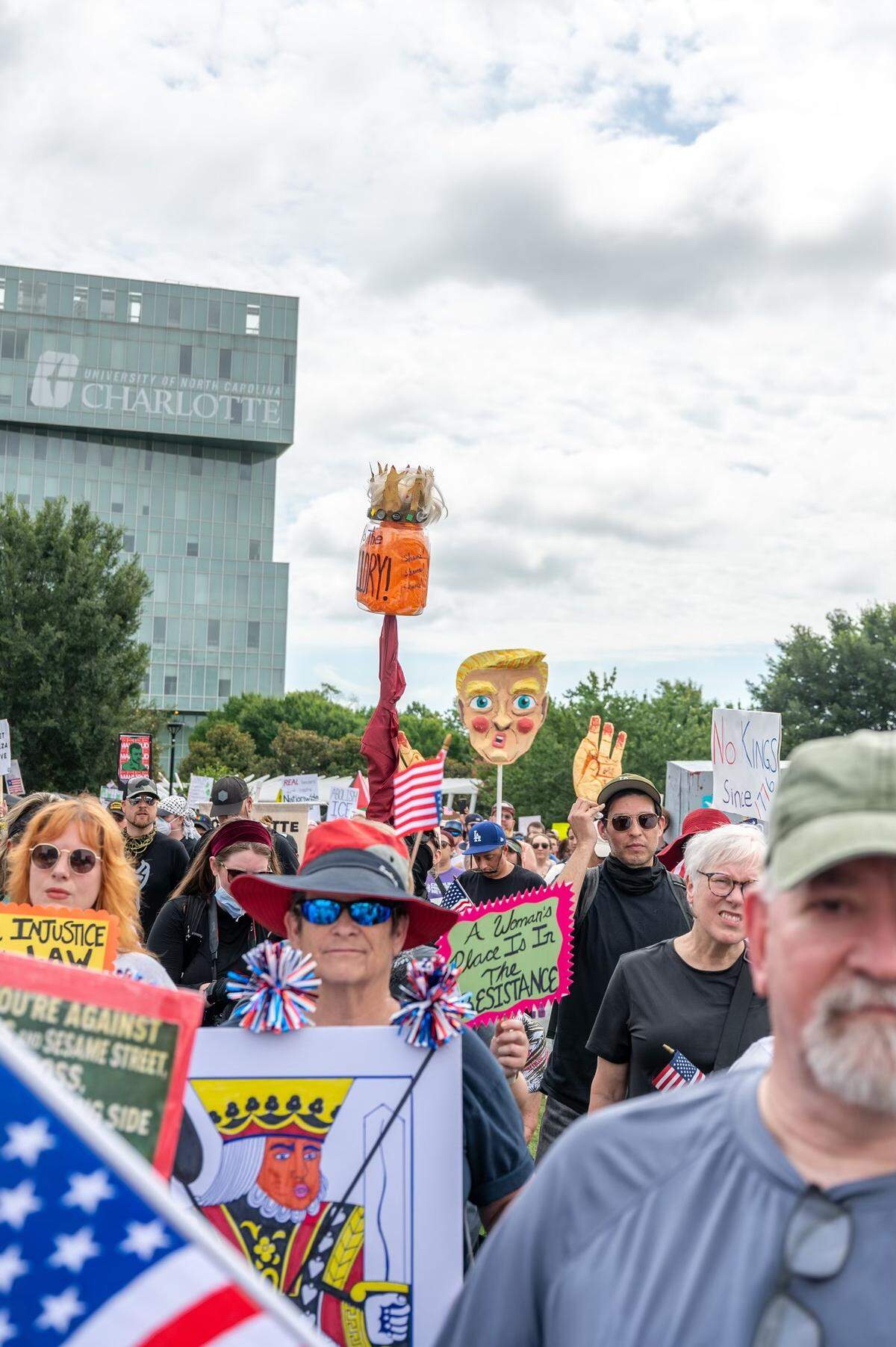 Signs mocking President Trump are held up at the No Kings rally and march at First Ward Park in Charlotte, NC, Saturday, June 14, 2025.
