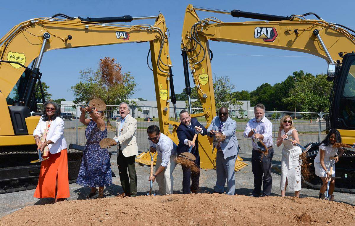 Charlotte City Council members toss dirt into the air as they participate in the groundbreaking for developer Crosland Southeast’s mixed-use project on the long dormant Eastland Mall site on Wednesday, August 3, 2022.