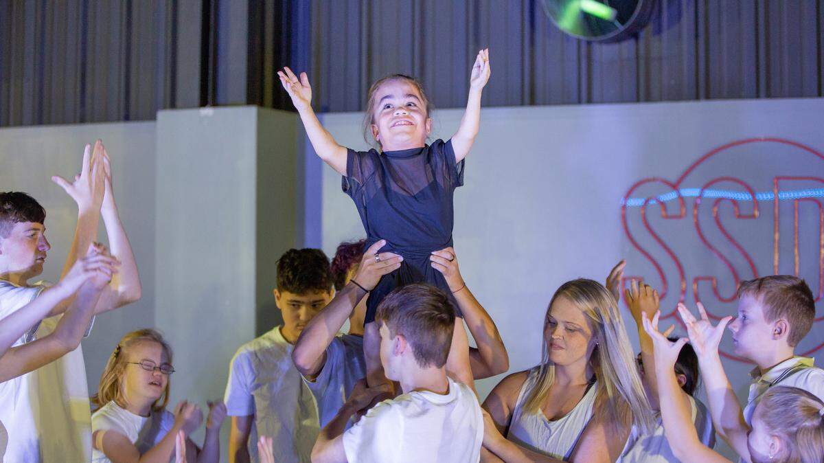 Dancers practice lifting A Chance to Dance dancer Ava Whipple during a rehearsal at Star Struck Dance Studio in Denver.