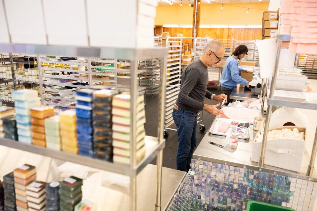 Employees pack orders at the warehouse for Sparta Candle Co.