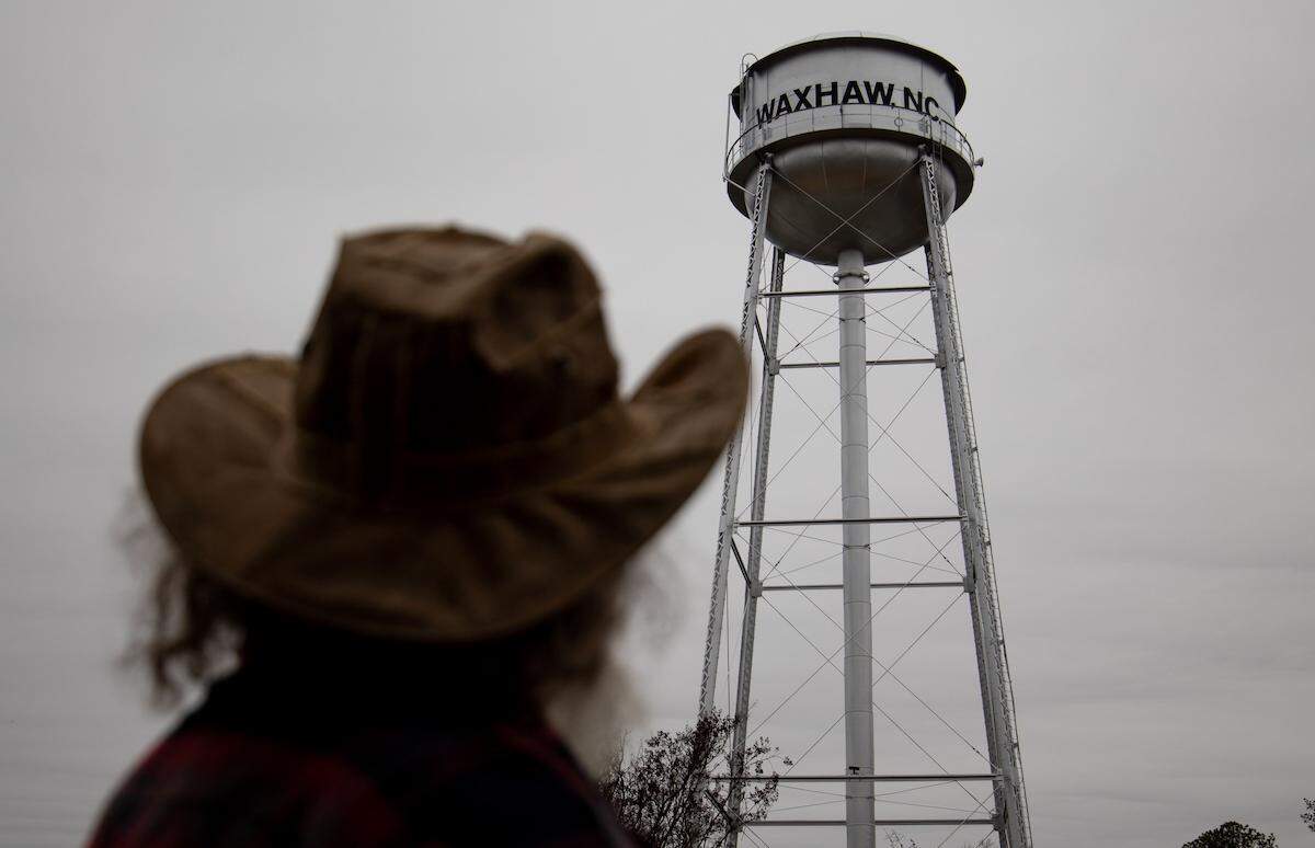 Crossroads Coffee House. owner Mike Holliday looks upward to the Waxhaw water tower. 