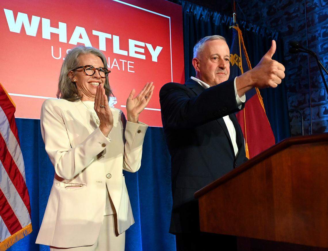 Suzanne Whatley, left, applauds as her husband, Michael Whatley, right, gives the thumbs up to supporters following his victory speech on Tuesday, March 3, 2026 at Noble Smoke in Charlotte, NC. Whatley won the Republican Party Primary for U.S. Senate.