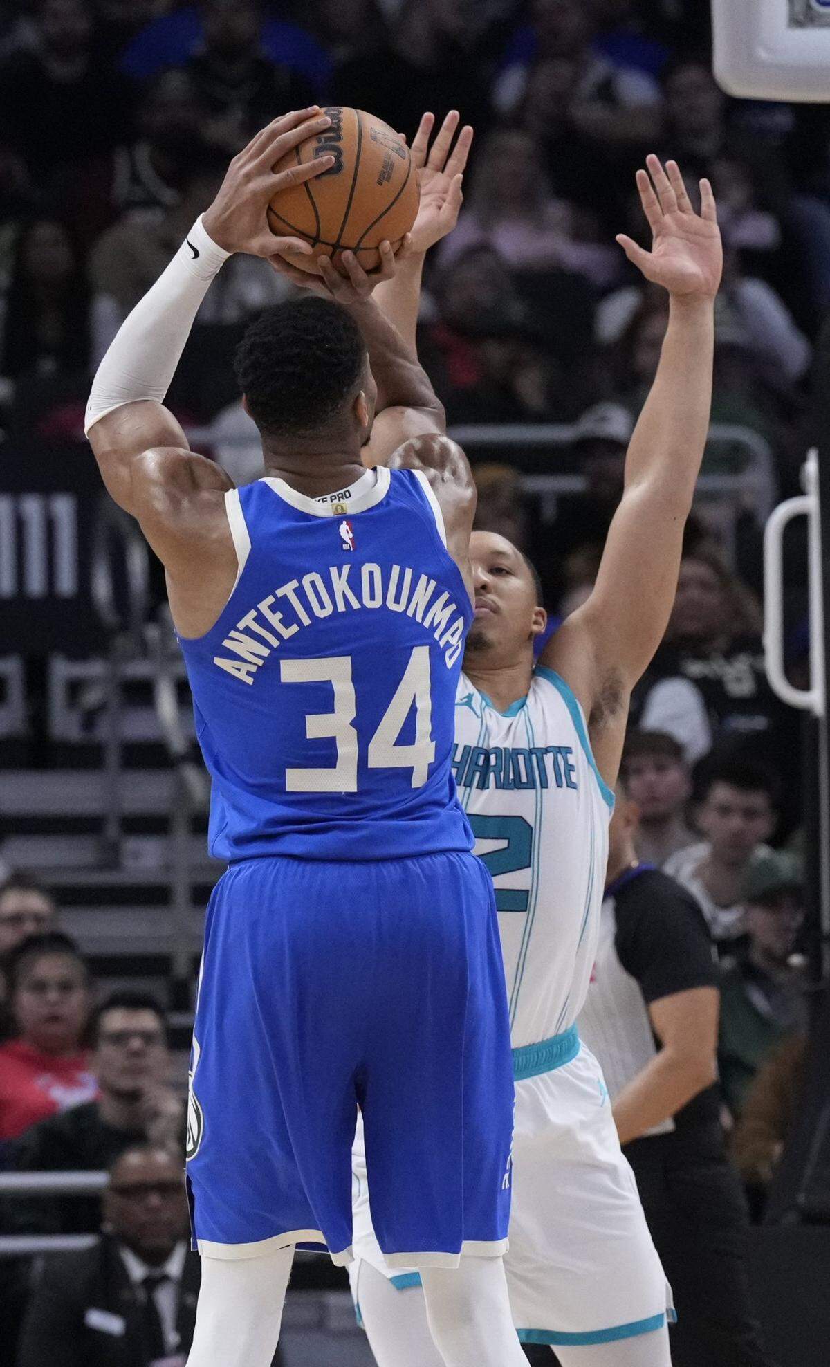 Milwaukee Bucks forward Giannis Antetokounmpo (34) puts up a shot against Charlotte Hornets forward Grant Williams (2) in the second half at Fiserv Forum. 
