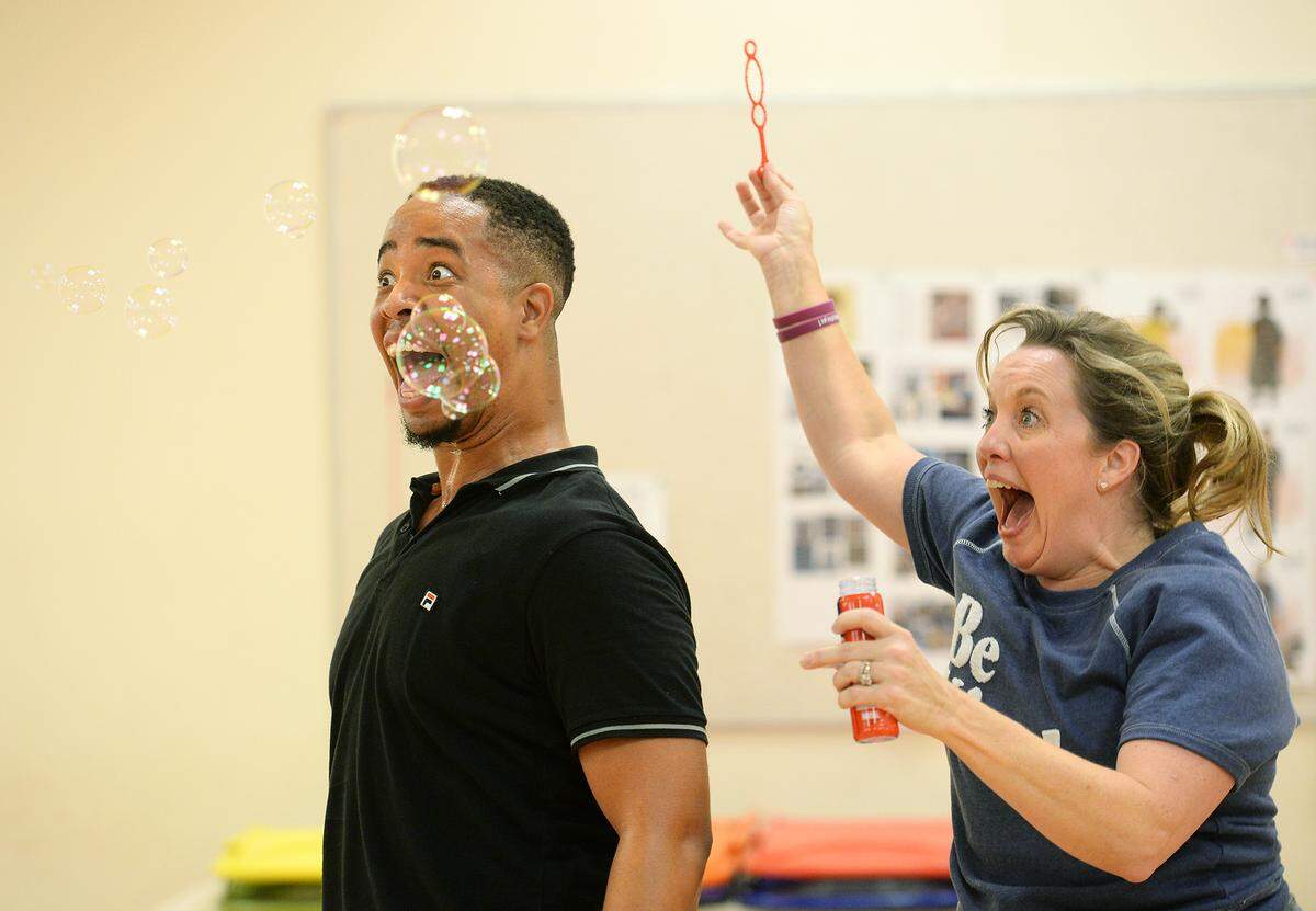 Mumford the Dragon (Ron Lee McGill), who is happy to blow soap bubbles instead of flames, gets some help from Magical Minion (Allison Rhinehardt) during rehearsal for “Last Stop on Market Street.”