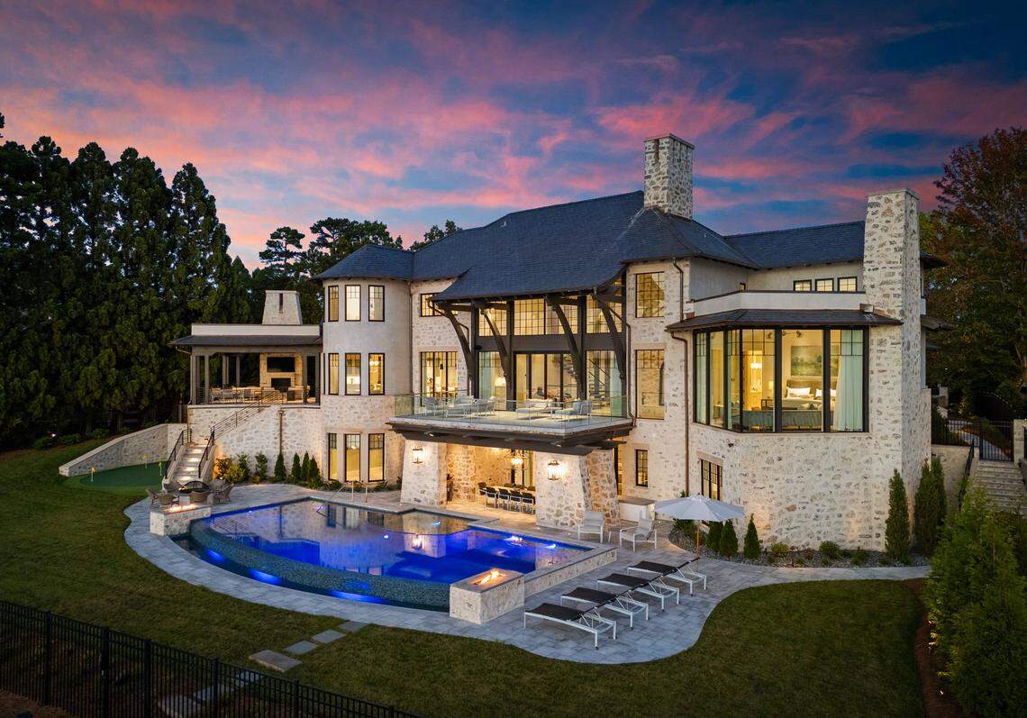 Live a resort-style life outdoors, where a private gated yard features a hand-laid cobblestone driveway, saltwater infinity pool with a spa, and a firepit, fireplace and grilling patio.