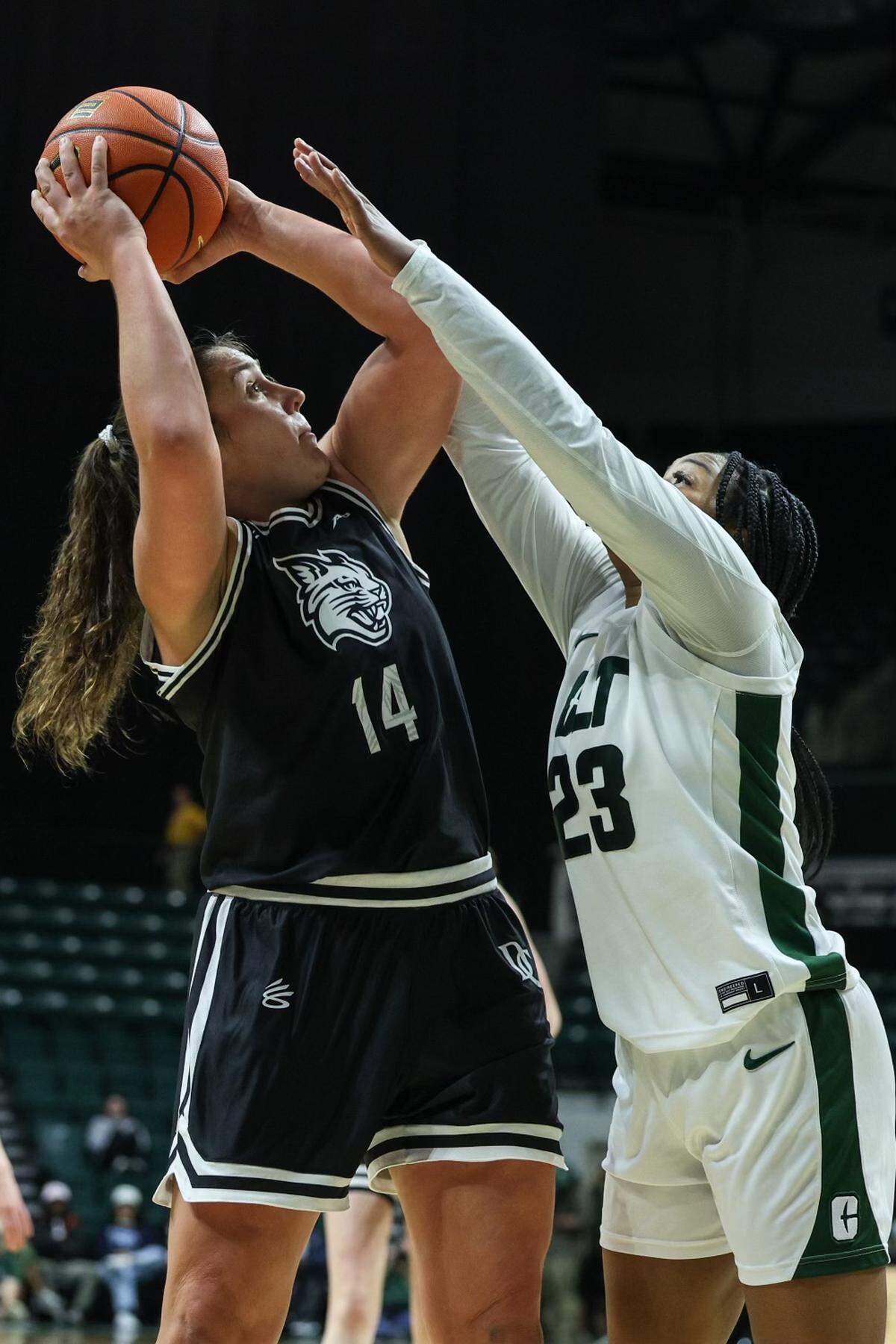 Davidson’s Maddie Plank (14) shoots over UNC-Charlotte’s Olivia Porter (23) during the game at Halton Arena on Thursday, December 21, 2023.