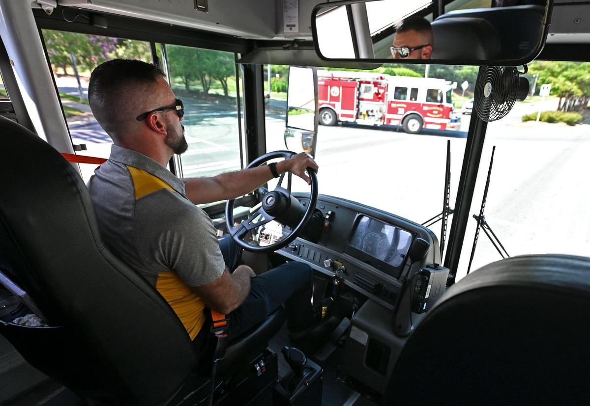 Adam Johnson, the CMS Executive Director of Transportation drives to E.E. Waddell High School on Wednesday, July 26, 2023. CMS held a press conference discussing the new Express Stops program that is coming to CMS for the 2023-2024 school year.