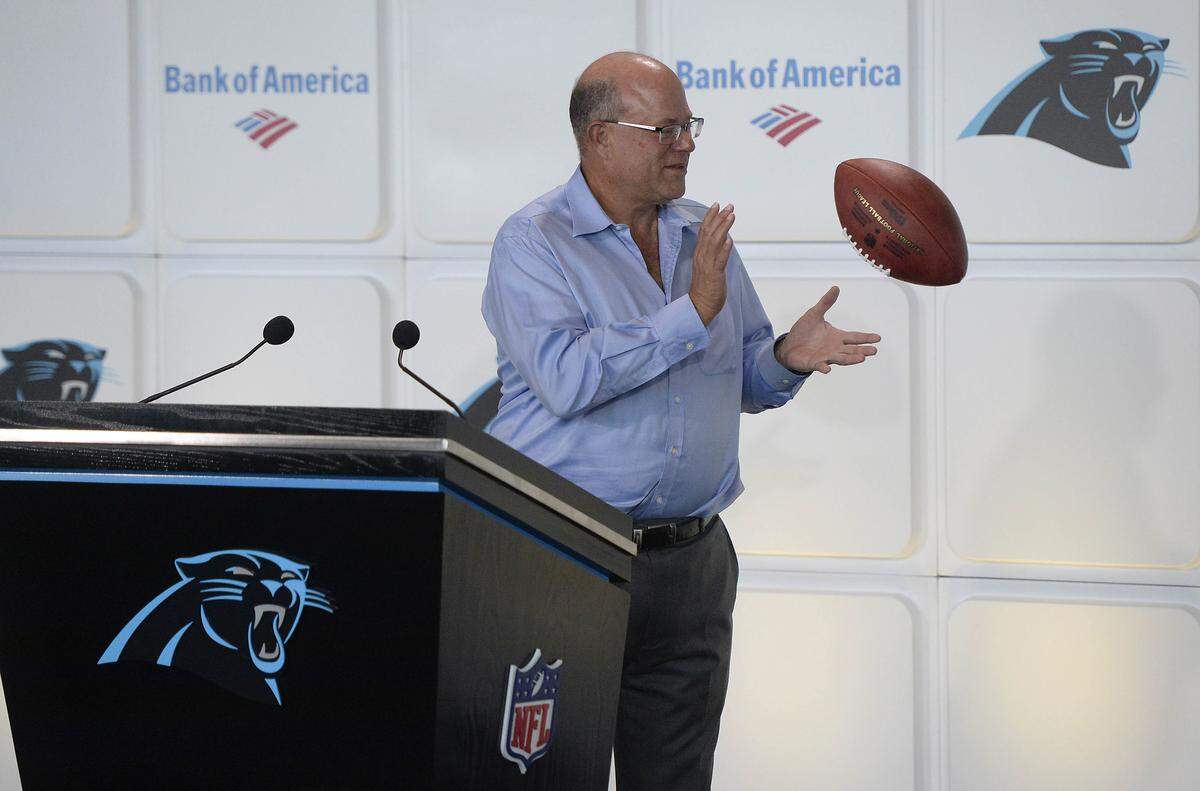 Billionaire hedge-fund manager David Tepper, the new owner of the Carolina Panthers, reaches out for a ceremonial ball tossed to him at the conclusion of his introductory press conference at Bank of America Stadium on Tuesday, July 10, 2018 in Charlotte, N.C. (David T. Foster III/Charlotte Observer/TNS)