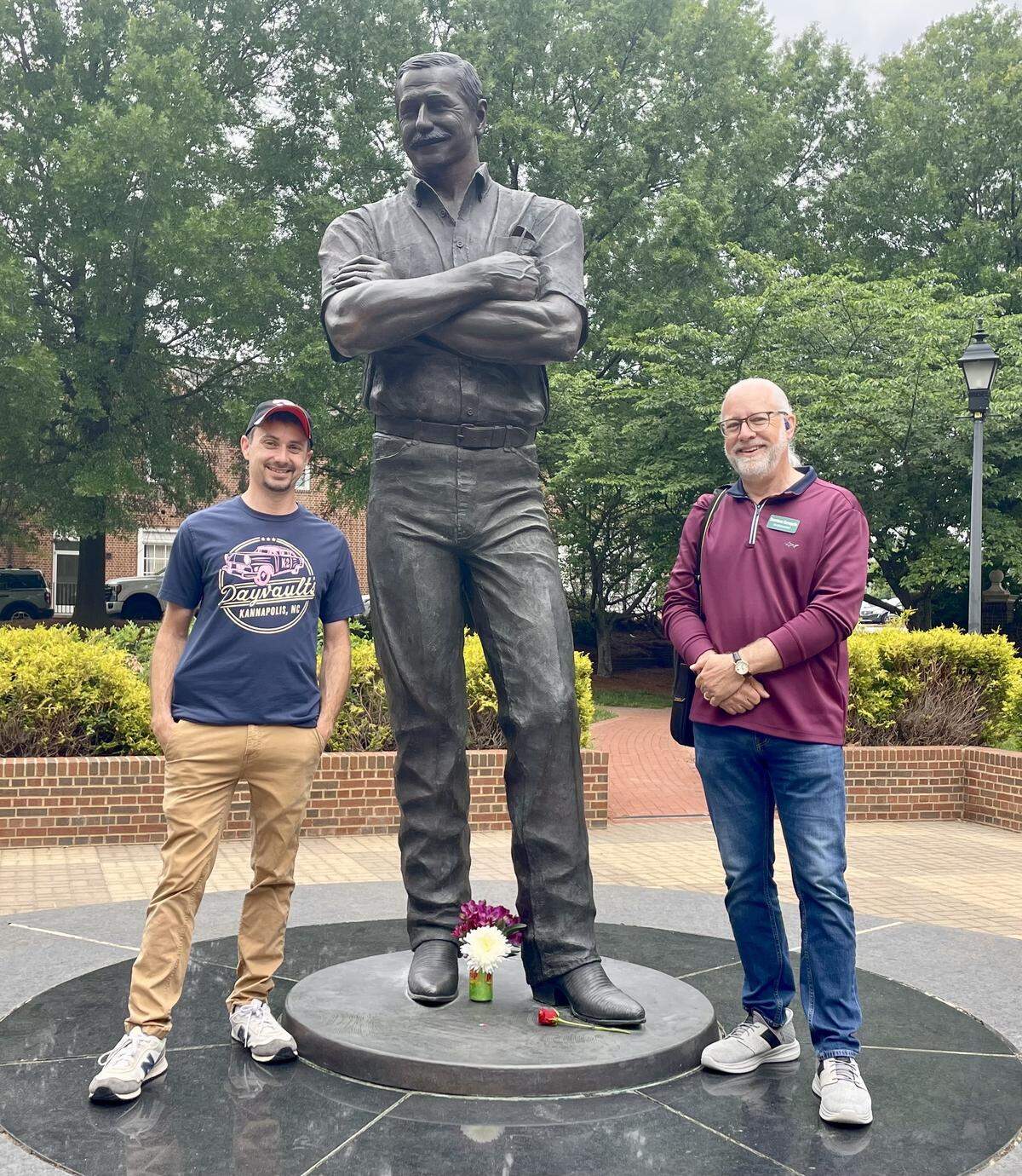 Kannapolis natives Ryan Dayvault, left, and Eric Dearmon stand next to Dale Earnhardt Sr.’s statue on Wednesday, April 29, what would have been his 75th birthday.
