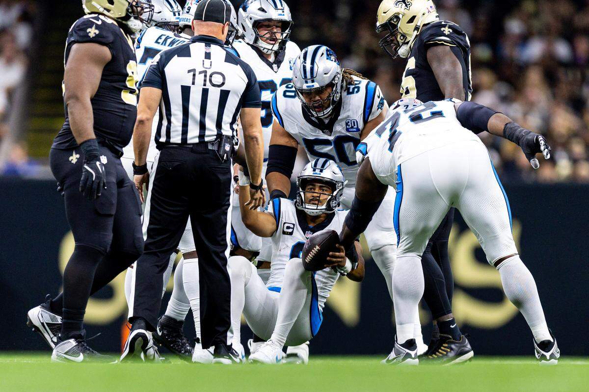 Carolina Panthers quarterback Bryce Young (9) helped off the turf after a sack against the New Orleans Saints during the first half at Caesars Superdome.