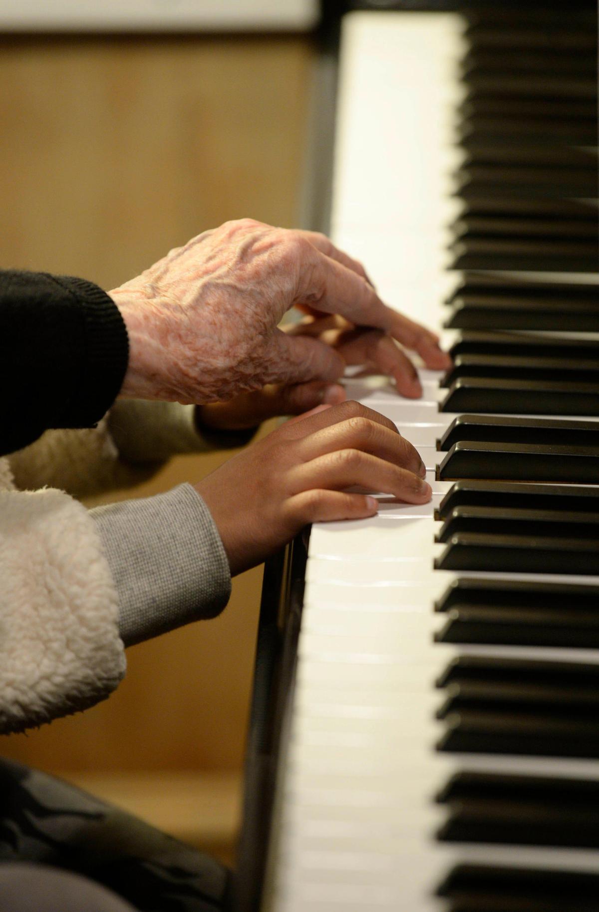 Dzidra Reimanis, a 92-year-old piano teachers, places her hand on the hand of student Kendall McKnight, 6, during a lesson in Reimanis’ home on Thursday, February 6, 2020. Reimanis has been teaching piano in Charlotte for more than 50 years