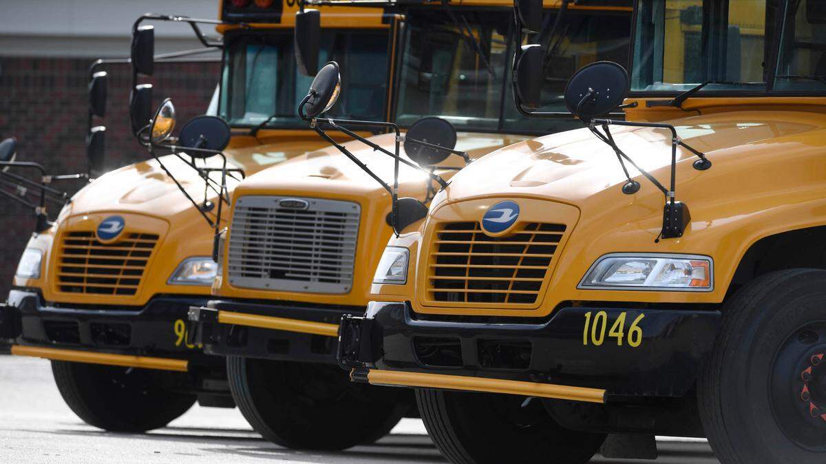 Buses wait for students to board at the end of the day at Ballantyne Elementary School on Tuesday, March 9, 2021.