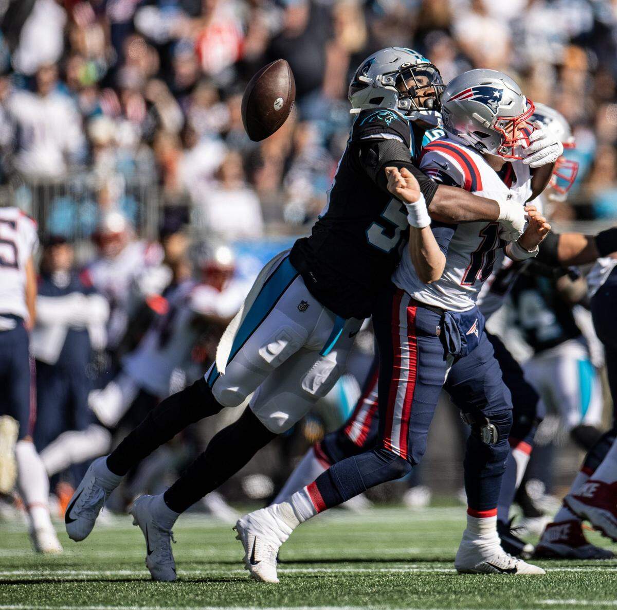 Brian Burns sacks New England Patriot quarterback Mac Jones in 2021, one of his nine sacks that year.