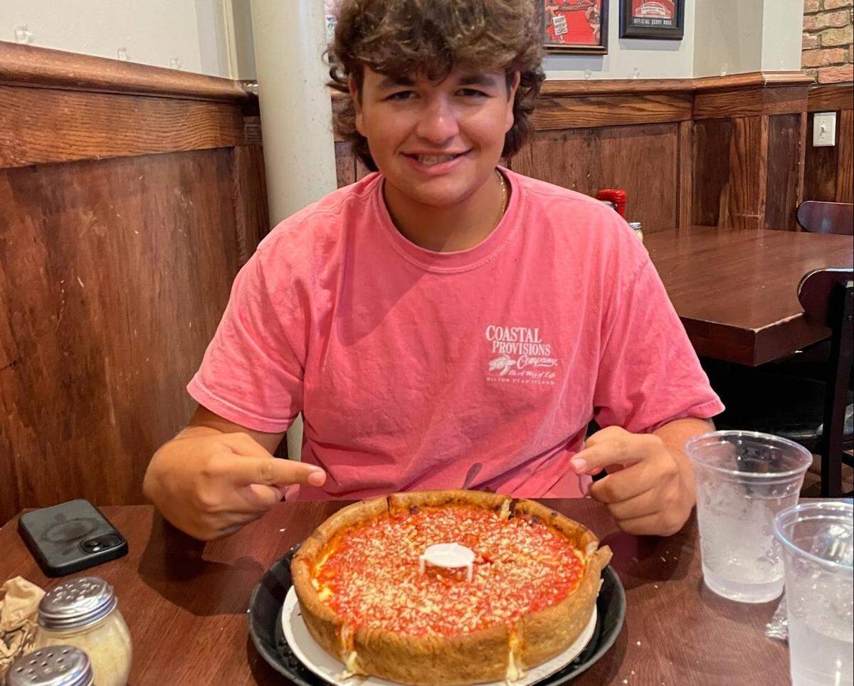 Brady Graziano with Rosati’s deep dish pizza.