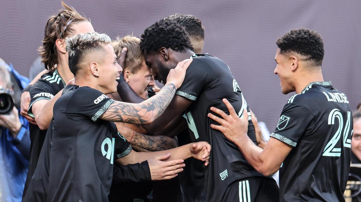 Charlotte FC players celebrate a goal scored by Karol Swiderski (middle) against FC Cincinnati at Bank of America Stadium in Charlotte on Saturday. Charlotte FC won, 2-0.