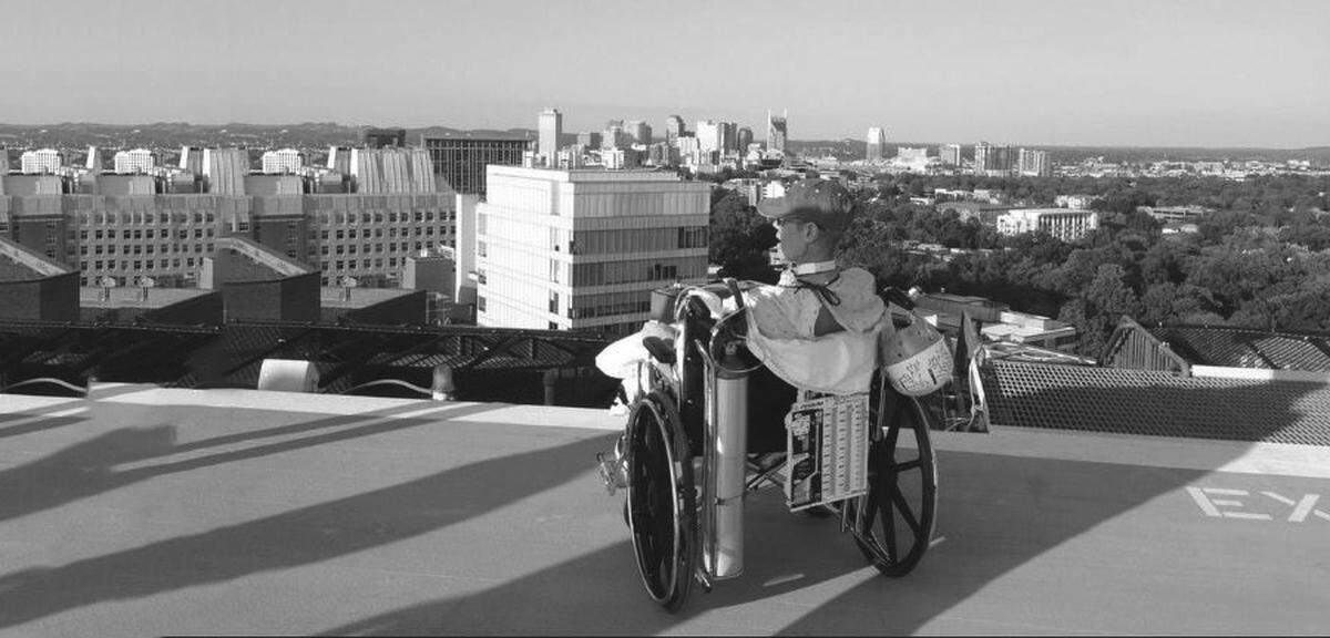 A photograph from Randy Travis’s 2019 autobiography, “Forever and Ever, Amen: A Memoir of Music, Faith, and Braving the Storms of Life.” The caption for it: “On the rooftop overlooking Nashville, wondering if I would ever be able to stand and sing again.”